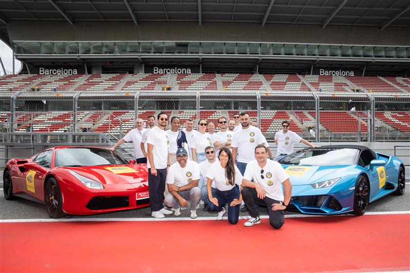 Ferrari 488 GTB and Lamborghini Huracán Evo with Magneti Marelli Parts & Services branding at Circuit de Montmeló with French partners wearing event t-shirts
