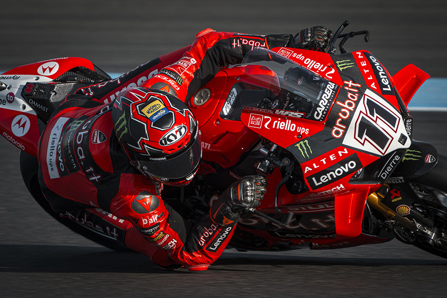 Nicolò Bulega cornering on the Aruba.it Racing team's Ducati Panigale V4R, wearing a Magneti Marelli Checkstar branded helmet